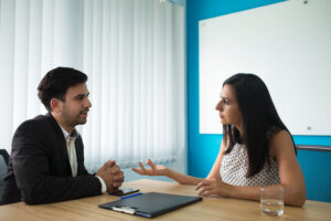 serious businesswoman businessman talking boardroom